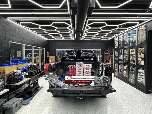 Hexagon LED ceiling lighting over a truck in an off-road shop in Glendora CA