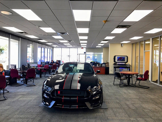 Ford dealership showroom in Lewisville TX lit with 2x4 LED drop ceiling panels